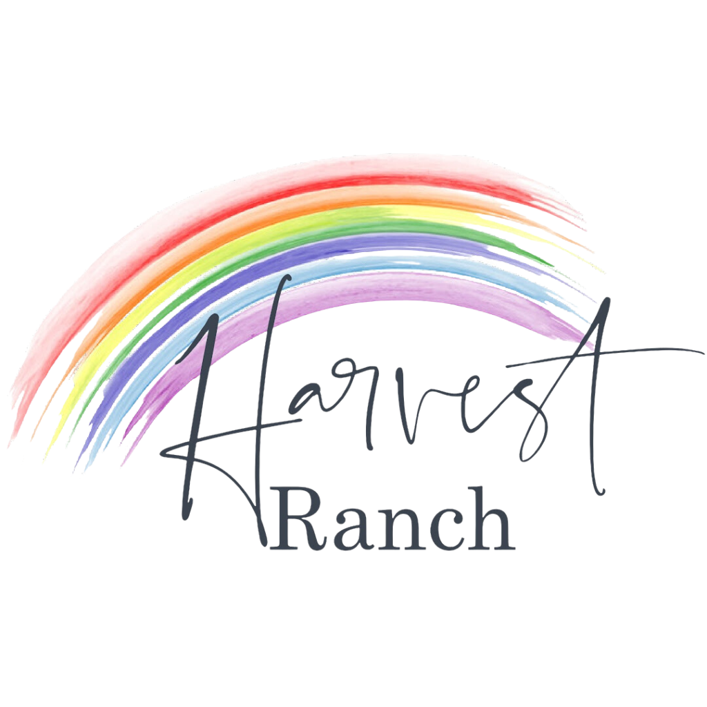 A rainbow with Harvest Ranch written underneath it