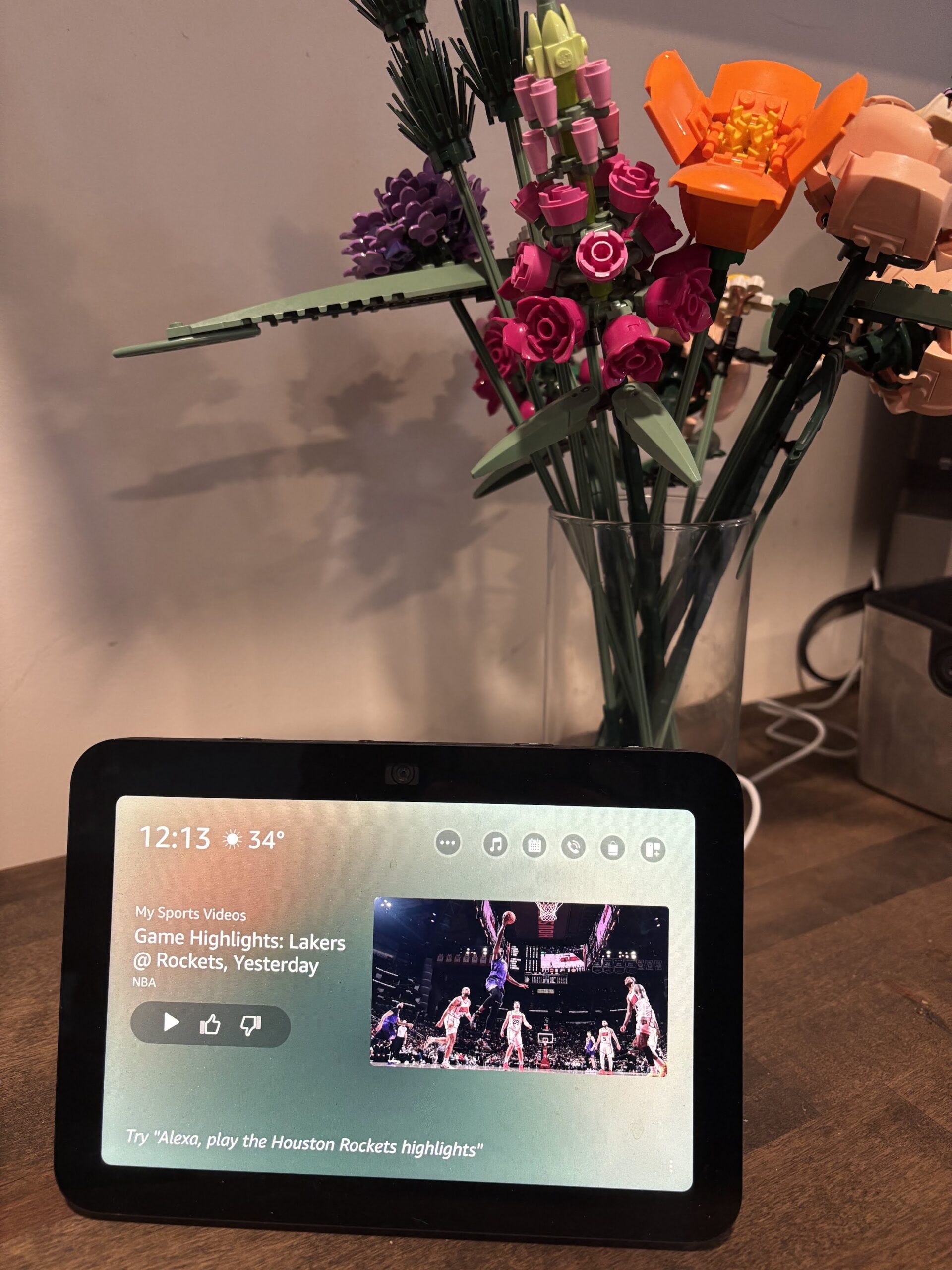 An Amazon Alexa Echo in the foreground, lego flowers in the background