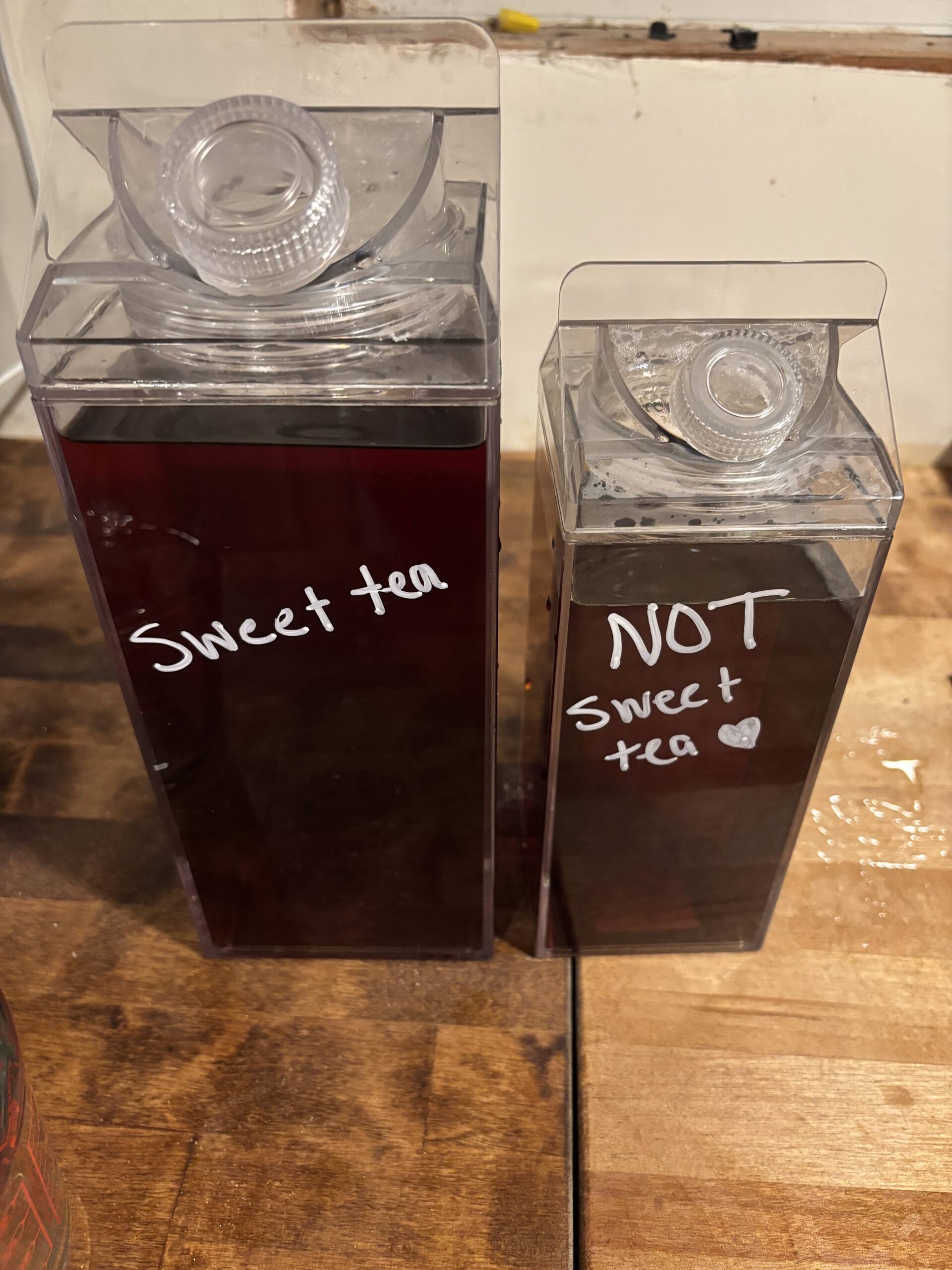 Sweet Tea and Unsweet Tea in Plastic Milk Pitchers sitting on a table