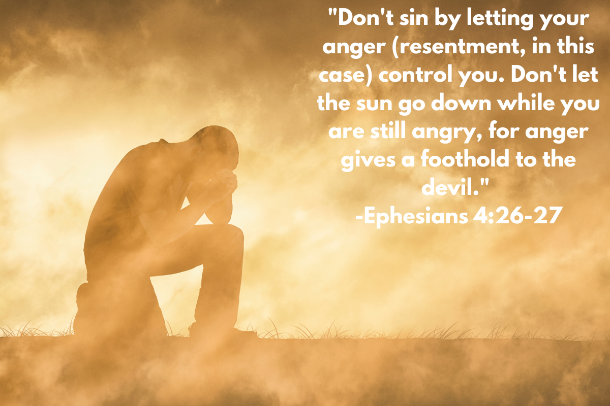 A man kneeling and praying on an orange background with white words from "Ephesians 4:26-27" dealing with resentment