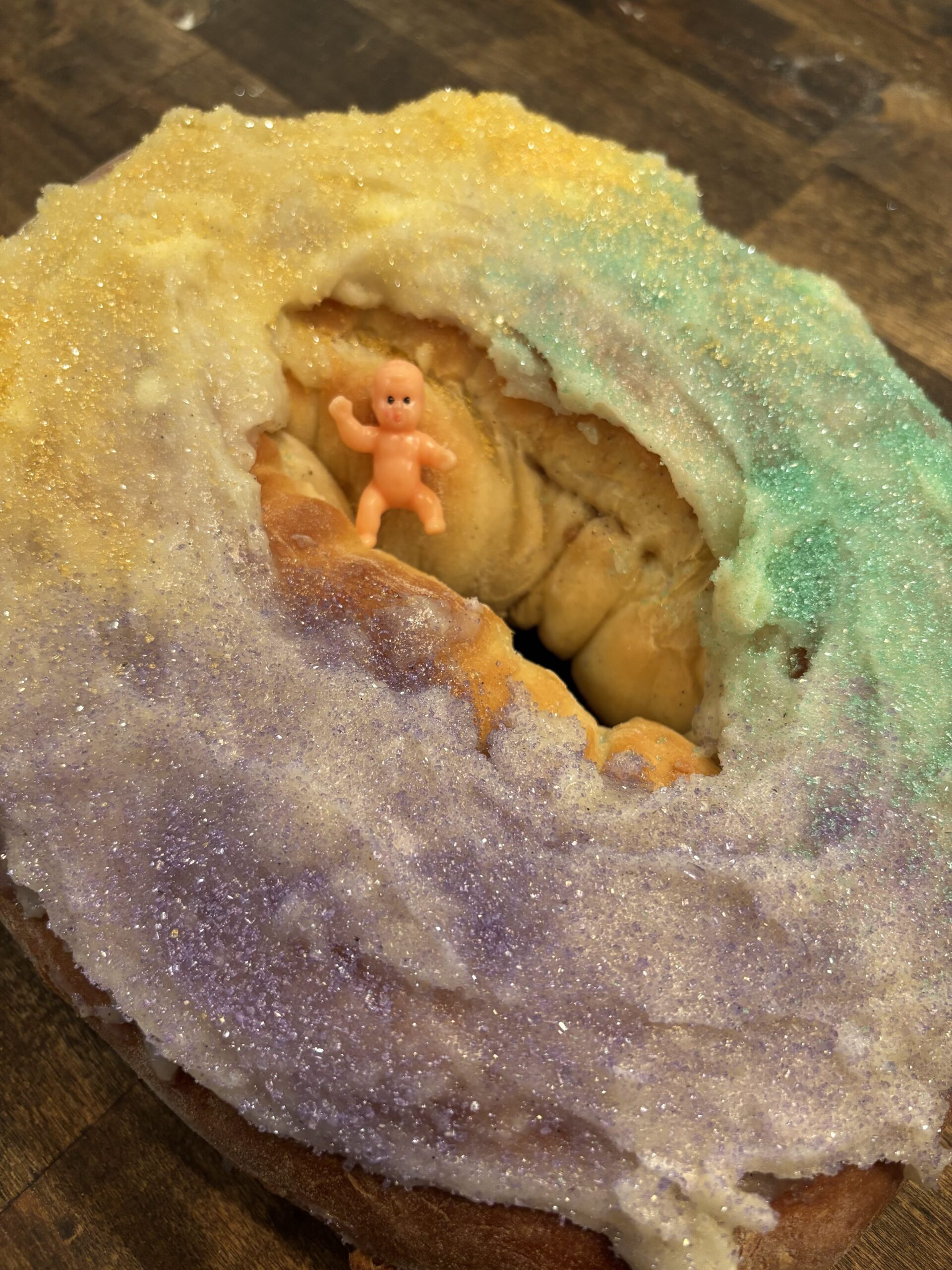 A King Cake with a baby in the middle